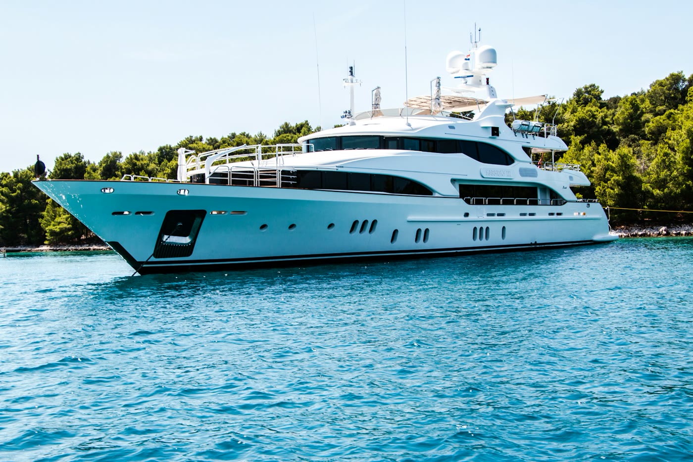 Motor yacht on calm blue water near a coastline