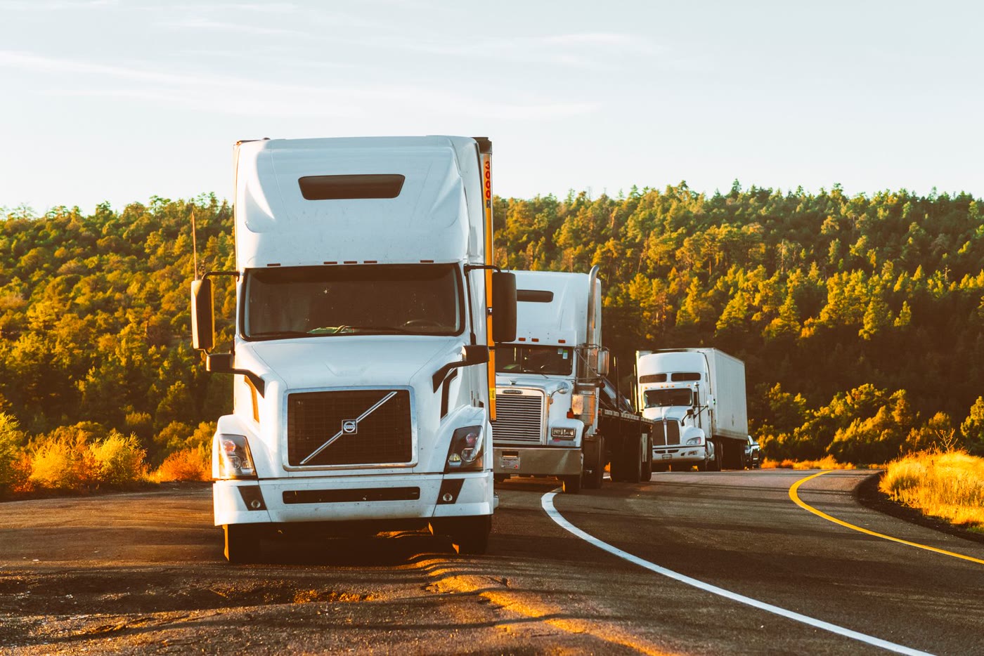 Commercial trucks traveling on a highway