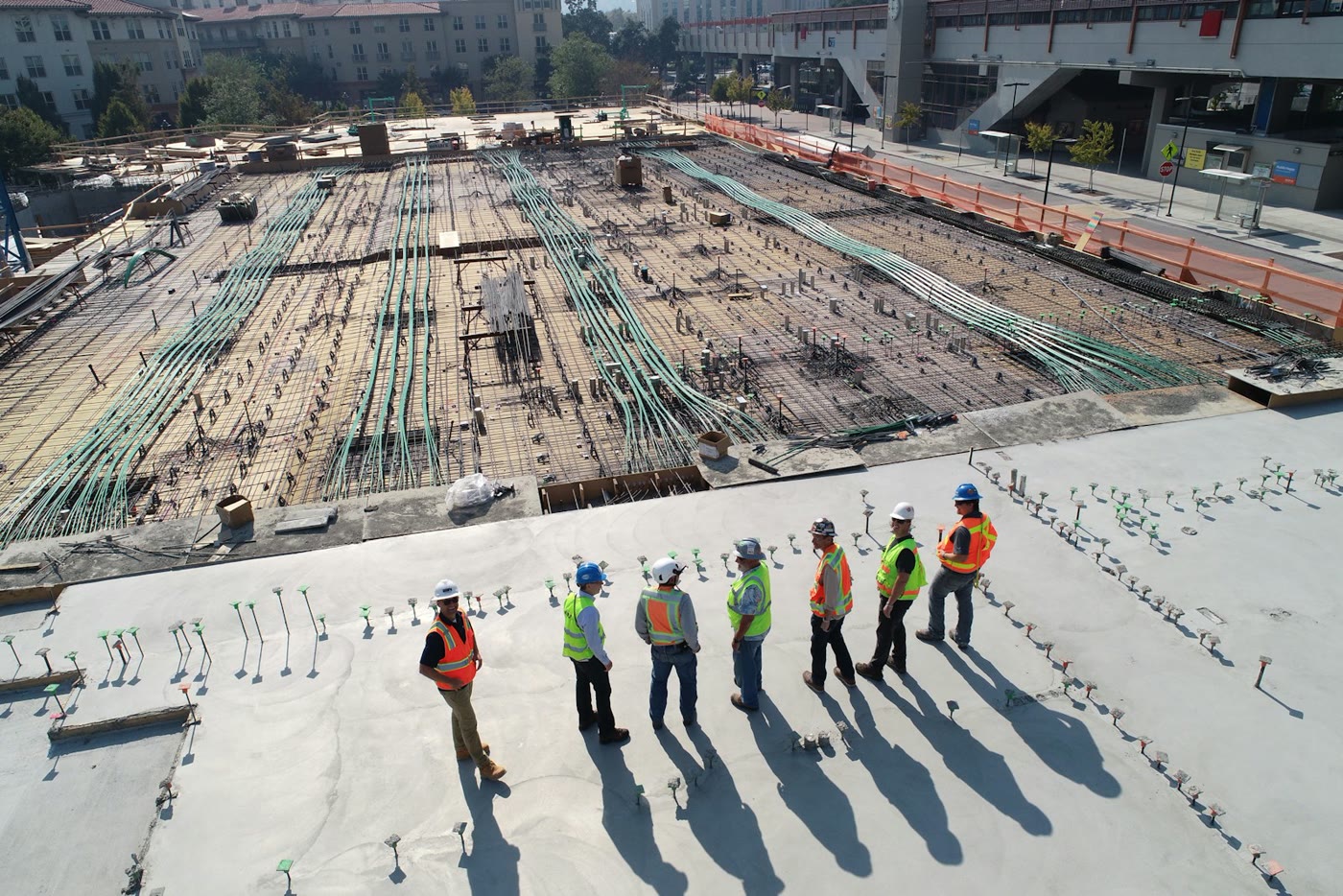 Contractors in hard hats reviewing a construction site